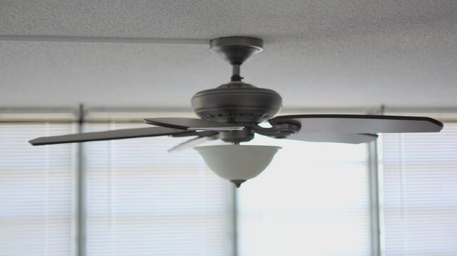 Celling fan slowly stop after spinning heavy wooden fins side look