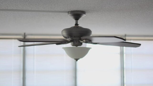 Celling fan middle speed spining heavy wooden fins side look
