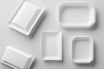 Assorted white food containers, various shapes and sizes, arranged on a light gray background.  Each container features clean lines and a simple design