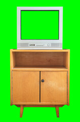 Old tv with cut out green screen isolated on green background stands on vintage nightstand from 1990s, 1980s. © lial88