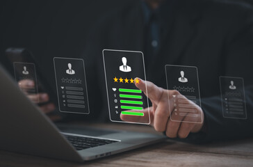 Businessman using laptop and mobile with virtual interface showing user profile, five-star rating,...