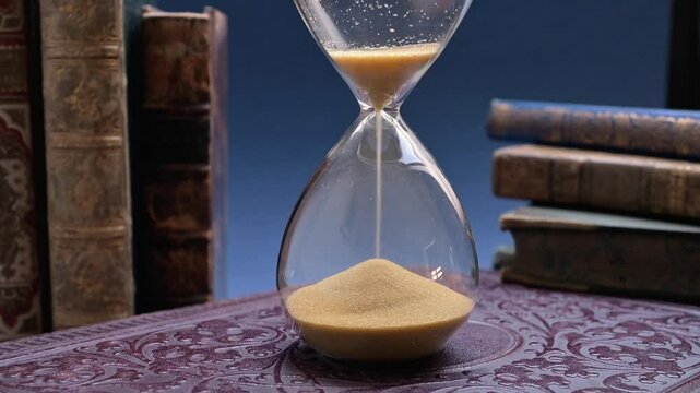 Sand passing through an hour glass
