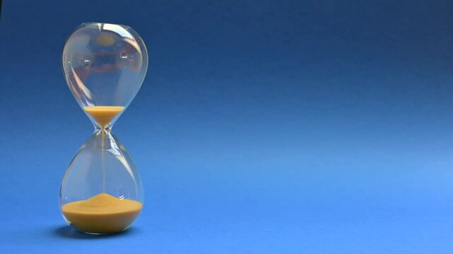 Sand passing through an hour glass
