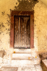 Weathered wooden door with concrete steps