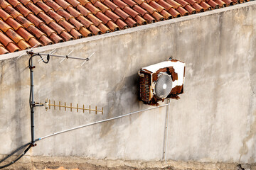 Rusty air conditioner unit on concrete wall