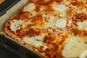 Cooking homemade pizza. Female hands making dough, adding sauce and ingredients.