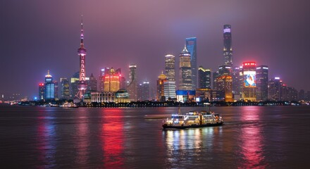 Obraz premium City skyline at night with illuminated buildings reflected in water and a boat.