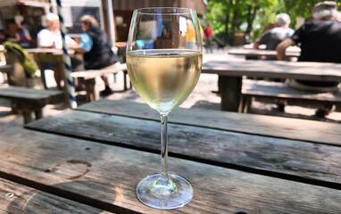 Chilled glass of white sauvignon wine at open air restaurant. Not only beer to drink at Bavarian beer garden