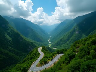 Scenic Winding Road through Lush Green Mountain Valley Landscape Aerial View
