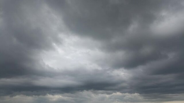 light gray and dark rain clouds that dissolve into light and blue sky appears on a rainy spring day