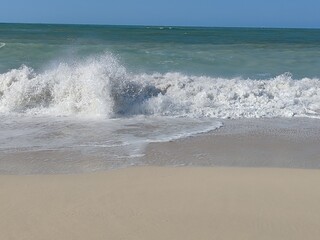 Water waves Sea Shore Beautiful Panorama white sand beach and turquoise water View.
Holiday summer beach background, Wave of sea on White sandy beach. Enjoy Holiday on Public Beach Heavy Water Waves