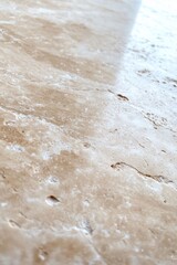 Close-up of light beige stone surface, showing natural veining and texture
