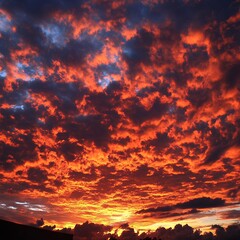 Fototapeta premium Fiery Sunset Sky Dramatic Cloudscape Orange Red Hues Burning Sky Evening view color scene vivid