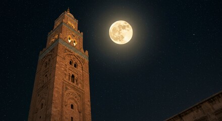 Mosque minaret under a full moon