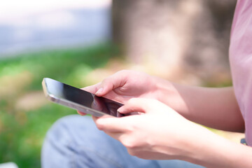 Young Asian Women Using Mobile Phone Learning Online Education Outdoor for Information and Entertainment