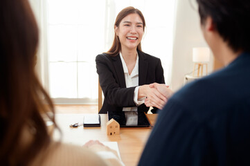 Professional Woman Shaking Hands With Clients in a Bright Office During a Business Meeting