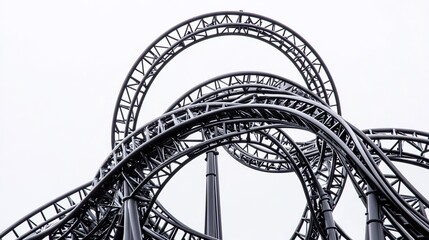 Dynamic upward view of a roller coaster track against bright sky