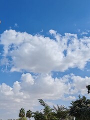 Obraz premium Cloudy SKY, Ornamental clouds, Blue SKY with light of sunshine having small and large clouds, Blue SKY with deep dark clouds, Dense Cloudy weather. Timelapse White clouds Panaromic view background 