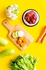 Natural pet food and ingredients - meat and vegetables zucchini, carrots and greens, cauliflower