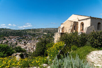 Fototapeta premium View of Scicli with San Matteo and Wildflowers