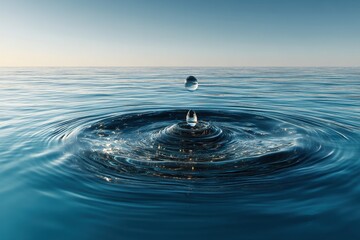 Water Drop Falling onto Surface of Blue Ocean Creating Ripples in Calm Waters