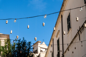 Hanging lights and corks in a street of Scicli