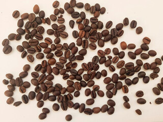 scattered coffee beans on white background