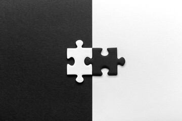 Black And White Puzzle Pieces Joining Together With Contrasting Background Design.
