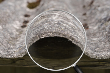 Old and very dangerous asbestos roof. Asbestos dust in the environment. Asbestos removal