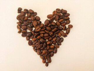 heart made of coffee beans on white background