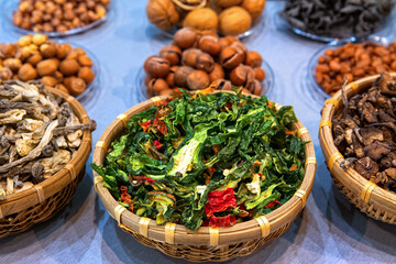 Dried chopped vegetables and mushrooms in wooden bowl, top view.