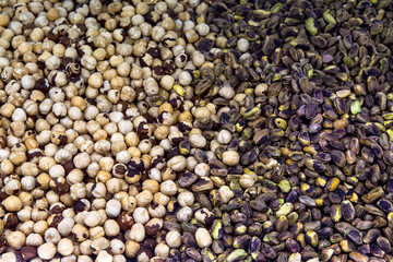 Peeled hazelnuts and pistachios top view. Nuts background.