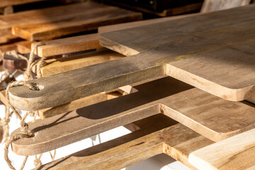 Stacked wooden cutting boards with rope handles