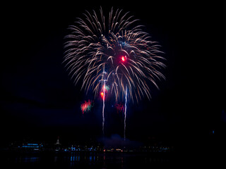 Multiple fireworks against the deep black sky. Bright display of the fireworks