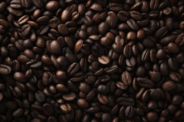 Fototapeta premium Roasted coffee beans fill the frame, rich browns and shadows create a warm, inviting texture.