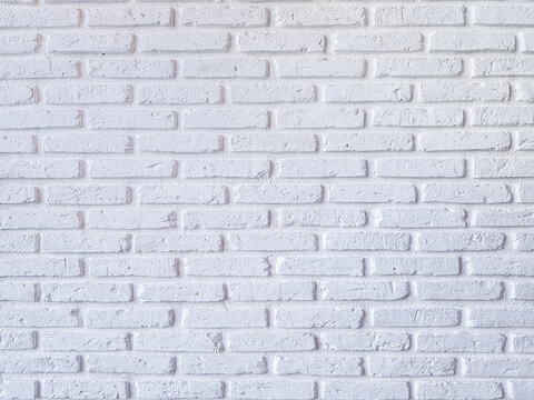 Fototapeta White brick pattern wall in loft style, construction background concept, clean cement scene.