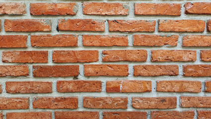 Red brick wall background, cement texture, solid stone construction in old building.