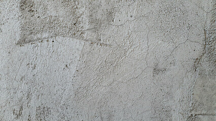 Close-up of plastered wall background, old grey plaster wallpaper, rough or uneven texture, construction work on building or structure floor.