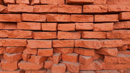 Red brick wall background, old ruined castle texture, piled up brick wallpaper.