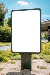 Vertical billboard mockup on roadside near bridge and greenery - mockup