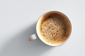 Overhead view of a cup of coffee with frothy crema.