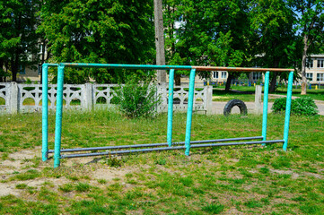 Outdoor workout playground with metal bars and climbing frames, old urban sports ground, sunny day,...