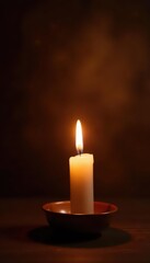 Lone candle flame glows warmly against rich brown backdrop, soft, image