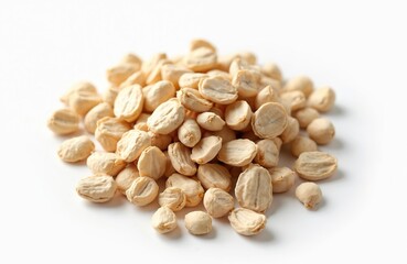 Pile of dried lotus seeds on white background. Organic, healthy food ingredient. Edible seeds used in traditional Asian medicine, cooking. Nourishing, delicious tasty produce.