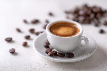 Obraz premium Espresso shot in a white cup, surrounded by coffee beans.