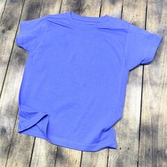Vintage style t-shirt mockup with an aged 90s look stretched on rustic wood