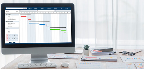 Project planning software for brisk business project management on the computer screen showing...