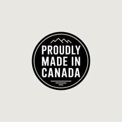 Fototapeta premium Proudly Made in Canada Badge with Maple Leafs and Mountains