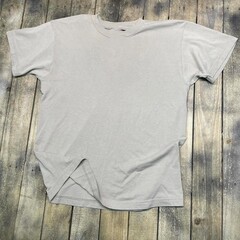 Vintage style t-shirt mockup with an aged 90s look stretched on rustic wood