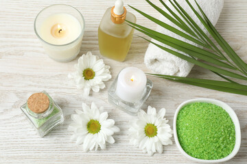 Beautiful spa composition with sea salt, soap bar and flowers on, closeup